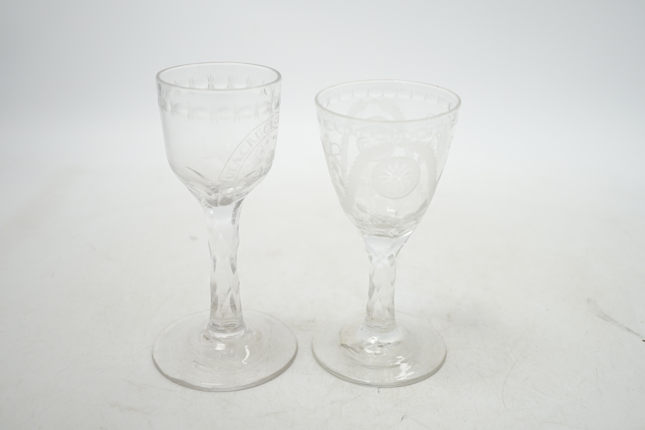 Two 18th century wine glasses with faceted stems, both with engraved bowls, one neo-classical and one reading ‘Via Crucis Via Lucis’, tallest 13.5cm. Condition - good